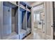 Mudroom with built-in cubbies and bench seating; doorway to laundry room with washer and dryer visible at 4745 Cuyahoga Cv, Suwanee, GA 30024