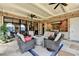 Covered outdoor kitchen and patio with comfortable seating, grill, and access to a beautiful view at 4745 Cuyahoga Cv, Suwanee, GA 30024