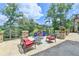 Inviting outdoor seating area on a stone patio with scenic views and stone balustrade at 4745 Cuyahoga Cv, Suwanee, GA 30024