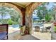 Inviting pool area with stone archway, comfortable seating, and lush landscaping provides a perfect outdoor retreat at 4745 Cuyahoga Cv, Suwanee, GA 30024
