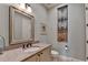 Stylish powder room featuring granite counters, framed mirror, and decorative wall art at 4745 Cuyahoga Cv, Suwanee, GA 30024