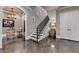 Beautiful staircase with wood treads and iron railing, flanked by wine barrels, enhances the lower level's ambiance at 4745 Cuyahoga Cv, Suwanee, GA 30024