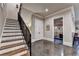 Elegant staircase with wood treads and wrought iron railing leads to finished basement with recreational area at 4745 Cuyahoga Cv, Suwanee, GA 30024