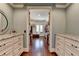Expansive walk-in closet with custom cabinetry and hardwood flooring at 4745 Cuyahoga Cv, Suwanee, GA 30024