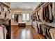 Spacious walk-in closet with custom storage solutions and hardwood floors at 4745 Cuyahoga Cv, Suwanee, GA 30024