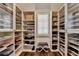 Well-organized walk-in closet featuring ample shelving and natural light at 4745 Cuyahoga Cv, Suwanee, GA 30024