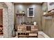 Rustic-style wine bar with custom storage and wine refrigerator at 4745 Cuyahoga Cv, Suwanee, GA 30024