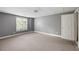 This basement area features carpeted floor, neutral paint and backyard access at 2108 Yorkshire Ct, Woodstock, GA 30189