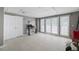 Finished basement with tile flooring, neutral paint and double door access to the yard at 2108 Yorkshire Ct, Woodstock, GA 30189