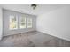 This bedroom has three sunny windows, neutral carpet, and fresh white walls at 2108 Yorkshire Ct, Woodstock, GA 30189