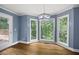 Bright dining room features hardwood floors, large windows with backyard views, and modern lighting at 2108 Yorkshire Ct, Woodstock, GA 30189
