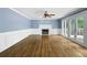 Spacious living room boasts hardwood floors, fireplace, and French doors to outdoor space at 2108 Yorkshire Ct, Woodstock, GA 30189