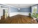 Open living room with hardwood floors, white trim, and a view into another room at 2108 Yorkshire Ct, Woodstock, GA 30189