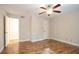 Bedroom with wood floors, ceiling fan, and view to another room at 408 River Run Dr, Sandy Springs, GA 30350