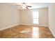 Bedroom with neutral walls, wood floors, ceiling fan, and a window at 408 River Run Dr, Sandy Springs, GA 30350