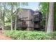 Exterior of building featuring multiple balconies and lush greenery at 408 River Run Dr, Sandy Springs, GA 30350