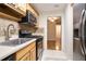Galley kitchen featuring stainless steel appliances and a view into the adjacent room at 408 River Run Dr, Sandy Springs, GA 30350
