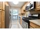 Galley kitchen with stainless steel appliances, light wood cabinets, and a window overlooking the deck at 408 River Run Dr, Sandy Springs, GA 30350
