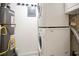 Laundry room featuring a stacked washer and dryer, and a water heater at 408 River Run Dr, Sandy Springs, GA 30350