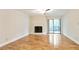 Bright living room featuring a fireplace, ceiling fan, and sliding glass doors to a private balcony at 408 River Run Dr, Sandy Springs, GA 30350