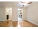 Living room with wood floors, neutral walls, and a view into the kitchen at 408 River Run Dr, Sandy Springs, GA 30350