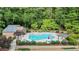 Community pool surrounded by lush greenery, lounge chairs, and shade structures at 408 River Run Dr, Sandy Springs, GA 30350
