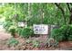 Welcome sign to River Run Private Residences with lush floral landscaping at 408 River Run Dr, Sandy Springs, GA 30350