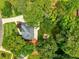 Aerial view of home with fire pit area, lush trees and landscaping in a serene neighborhood at 610 Woodstream Ct, Roswell, GA 30075