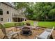 The backyard offers a cozy seating area with comfortable seating and a fire pit feature at 610 Woodstream Ct, Roswell, GA 30075