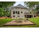 Beautiful backyard features a well maintained lawn and a patio area with a fire pit at 610 Woodstream Ct, Roswell, GA 30075