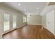 Spacious basement featuring laminate flooring, recessed lighting, and access to the backyard through double doors at 610 Woodstream Ct, Roswell, GA 30075