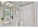Well-lit bathroom featuring a large mirror, a white vanity, and a shower-tub combination with bright lighting at 610 Woodstream Ct, Roswell, GA 30075
