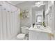 Well-maintained bathroom features a white vanity, round mirror, and shower with decorative curtain at 610 Woodstream Ct, Roswell, GA 30075