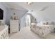 Bright bedroom with high ceilings, a cozy bed, and a large window offering an airy and inviting atmosphere at 610 Woodstream Ct, Roswell, GA 30075