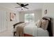 Comfortable bedroom with plush pillows, a decorative ceiling fan, and a bright window offering ample natural light at 610 Woodstream Ct, Roswell, GA 30075