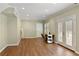Large flex room with hardwood floors, bright lighting, and a sewing and design area at 610 Woodstream Ct, Roswell, GA 30075