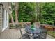 Outdoor deck with an outdoor table and chairs, perfect for entertaining or relaxing with a view of the landscape at 610 Woodstream Ct, Roswell, GA 30075