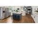 Gourmet kitchen with stainless steel appliances, island, and hardwood flooring at 610 Woodstream Ct, Roswell, GA 30075