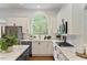 Modern kitchen with stainless appliances, gas range, and bright arched window at 610 Woodstream Ct, Roswell, GA 30075