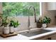 Close-up of the kitchen sink with views out of the window and modern fixtures at 610 Woodstream Ct, Roswell, GA 30075