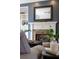 Close-up of living room fireplace with stone surround and built-in shelves on either side at 610 Woodstream Ct, Roswell, GA 30075