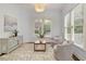 Bright living room with light gray walls, hardwood floors, and two comfortable chairs at 610 Woodstream Ct, Roswell, GA 30075