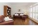 Cozy living room with hardwood floors and bright natural light from plantation shuttered windows at 610 Woodstream Ct, Roswell, GA 30075