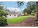 A sprawling backyard features a lush lawn and mature trees offering serenity at 645 Ruxbury Ct, Suwanee, GA 30024