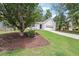 Attractive single-story home featuring a manicured lawn, tree cover, and a convenient two-car garage at 645 Ruxbury Ct, Suwanee, GA 30024
