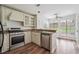 Bright kitchen with granite countertops, stainless steel appliances, and a view to the backyard through large windows at 645 Ruxbury Ct, Suwanee, GA 30024