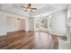 Open-concept living room with wood floors, a fireplace, and large windows for abundant natural light at 645 Ruxbury Ct, Suwanee, GA 30024