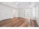 Large main bedroom featuring wood-look floors, white trim, double closets and French doors to the ensuite bathroom at 645 Ruxbury Ct, Suwanee, GA 30024