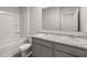 Bathroom featuring a double sink vanity, a tub with a shower, and neutral walls at 8223 Coldstream Dr, Fairburn, GA 30213
