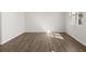 Secondary bedroom with durable, wood-look flooring and bright, sunny window at 8223 Coldstream Dr, Fairburn, GA 30213